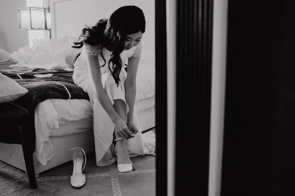 destination wedding cascais - bride putting shoes on