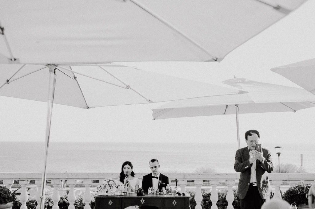 destination wedding cascais - family member taking a photo during ceremony