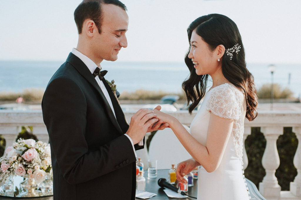 destination wedding cascais - groom giving bride the ring