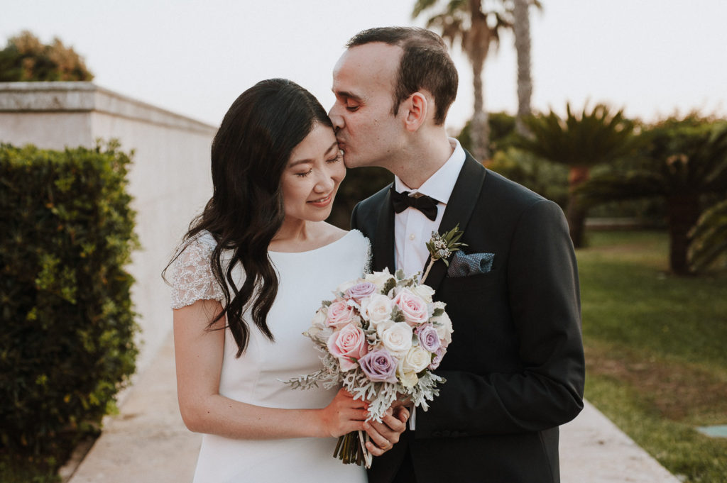 destination wedding cascais - groom kissing bride's forehead