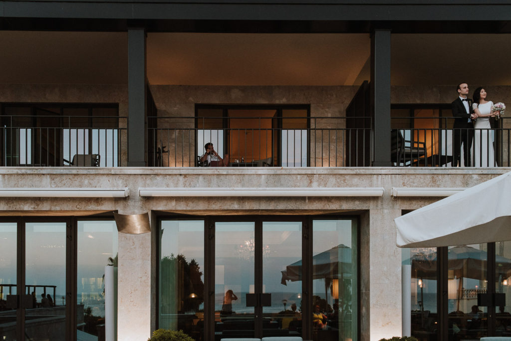 destination wedding cascais - bride and groom at balcony