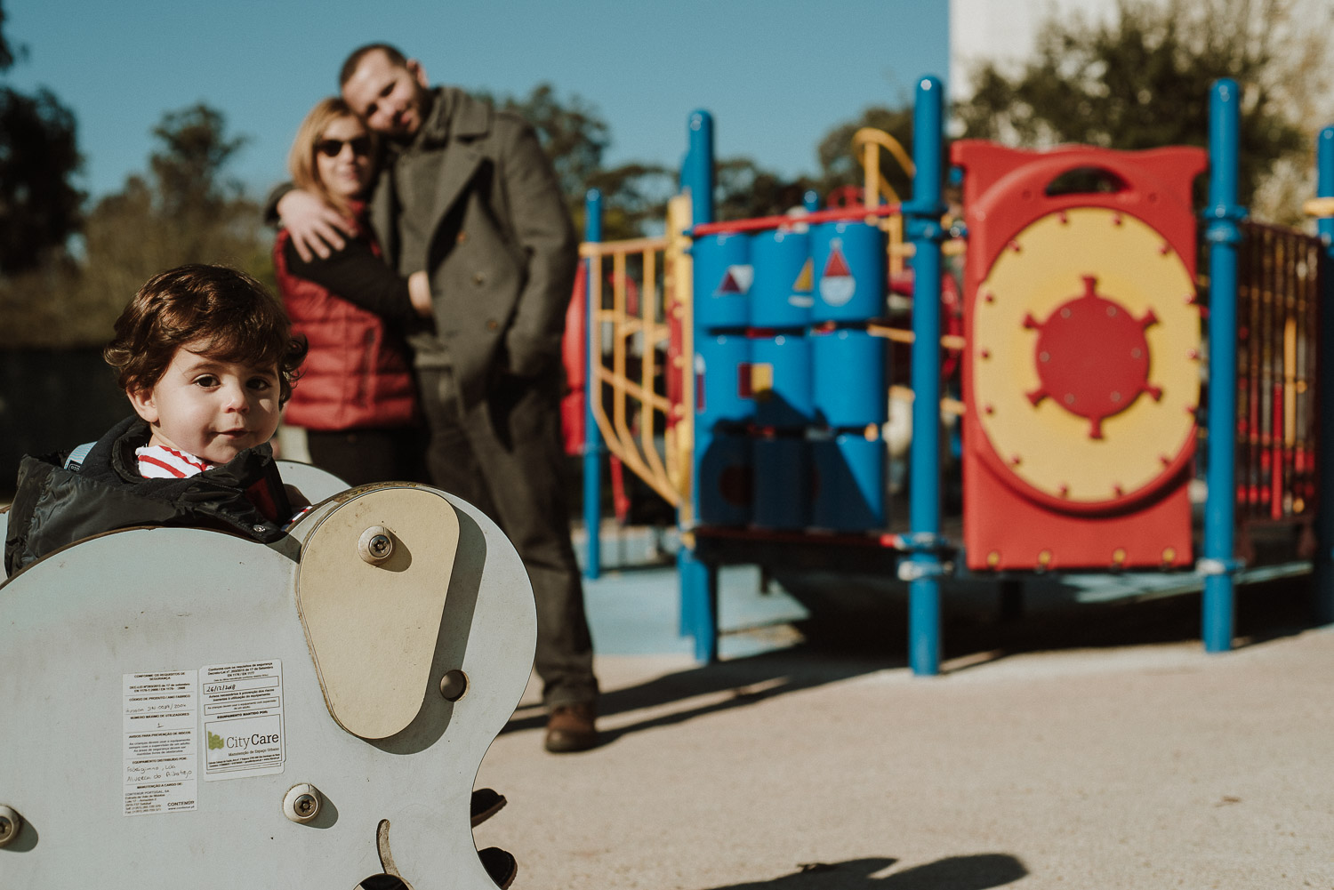 winter walk park wedding photographer parents hugging overlooking toddler - portugal wedding photographer family photographer