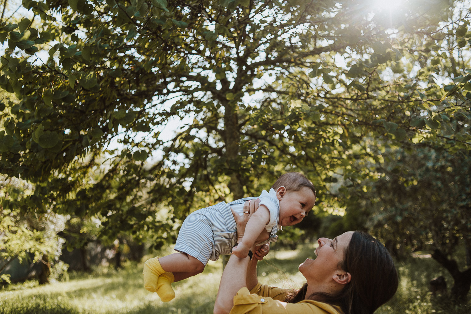 mom lifting baby - family wedding photographer portugal